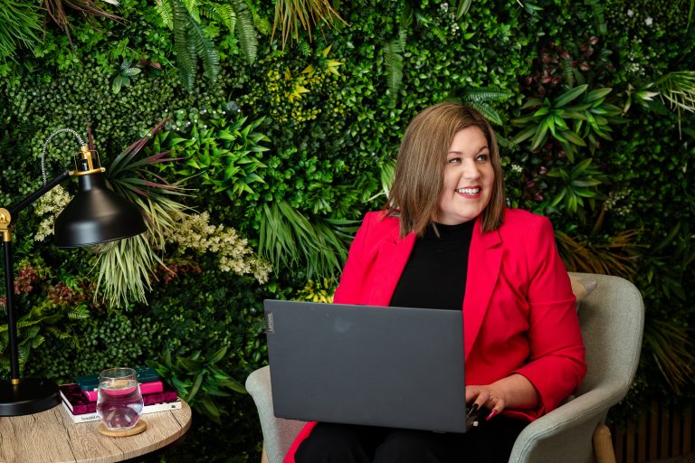 Shh! PR Founder Amie-Leigh sat on a chair with her laptop on her knee